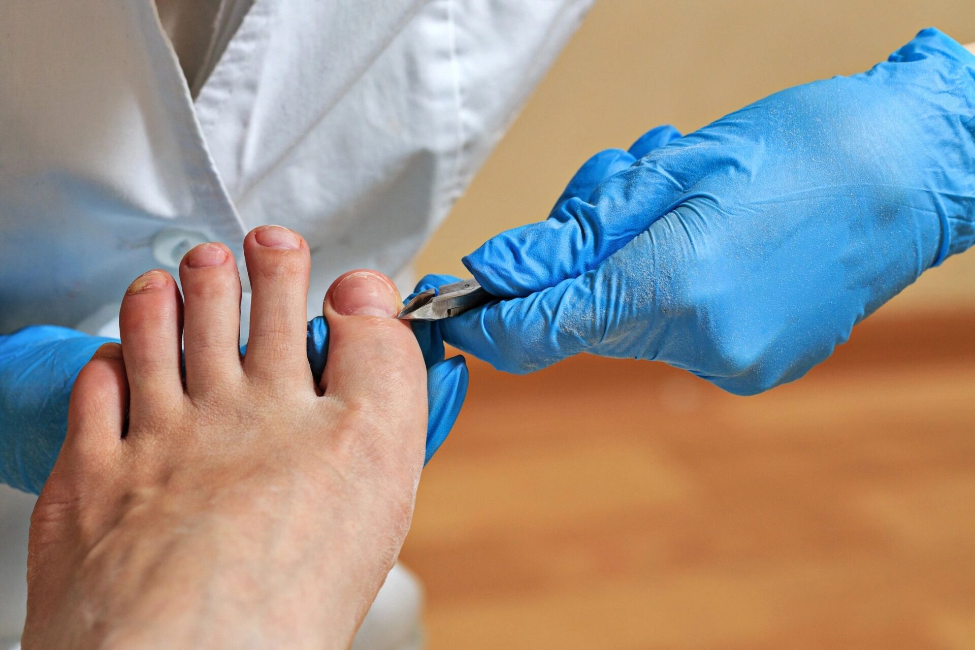 Mobile podiatrist providing in-home foot care to a patient.